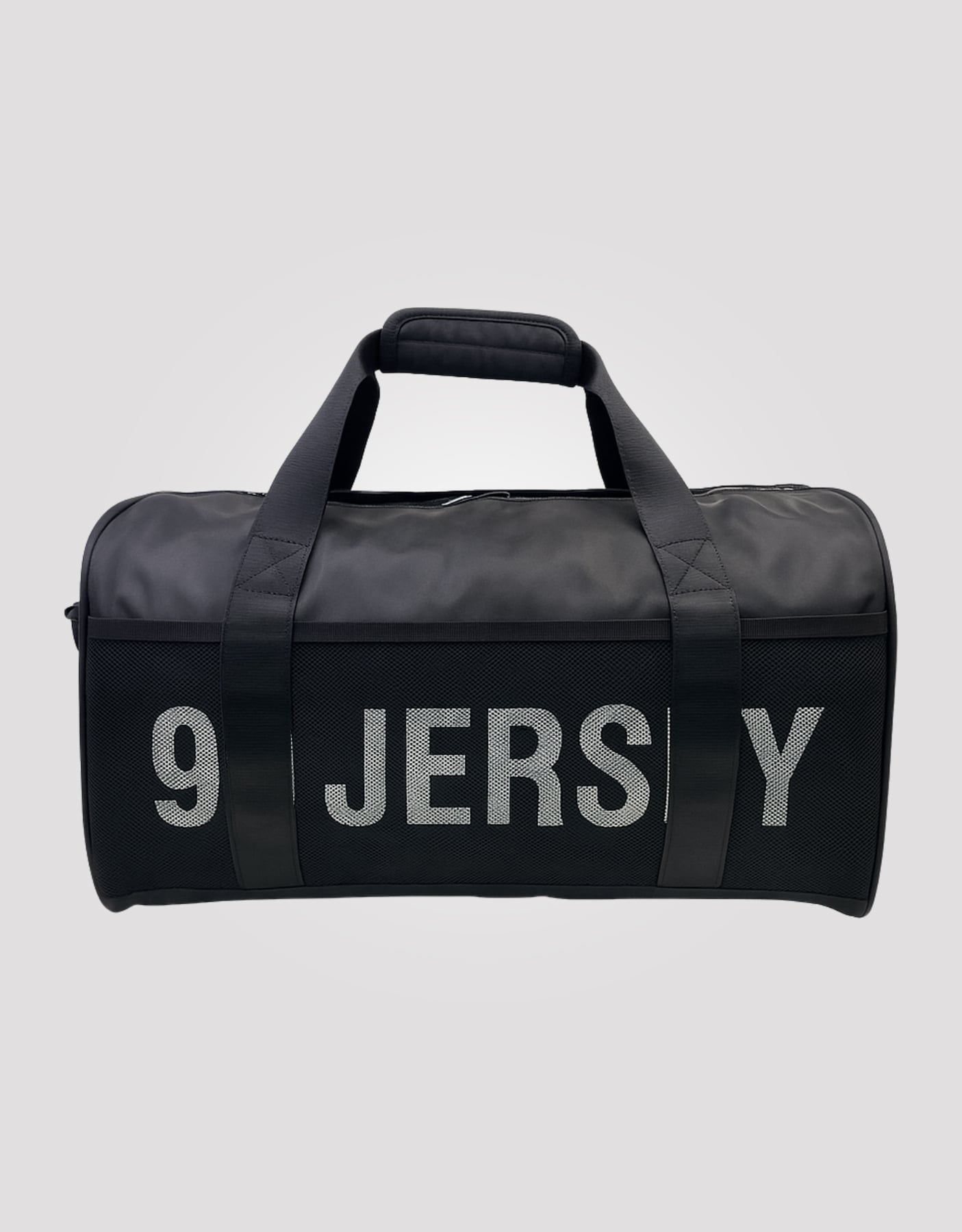 Black cylindrical sports duffel bag with 99 JERSEY text across the front in reflective grey lettering