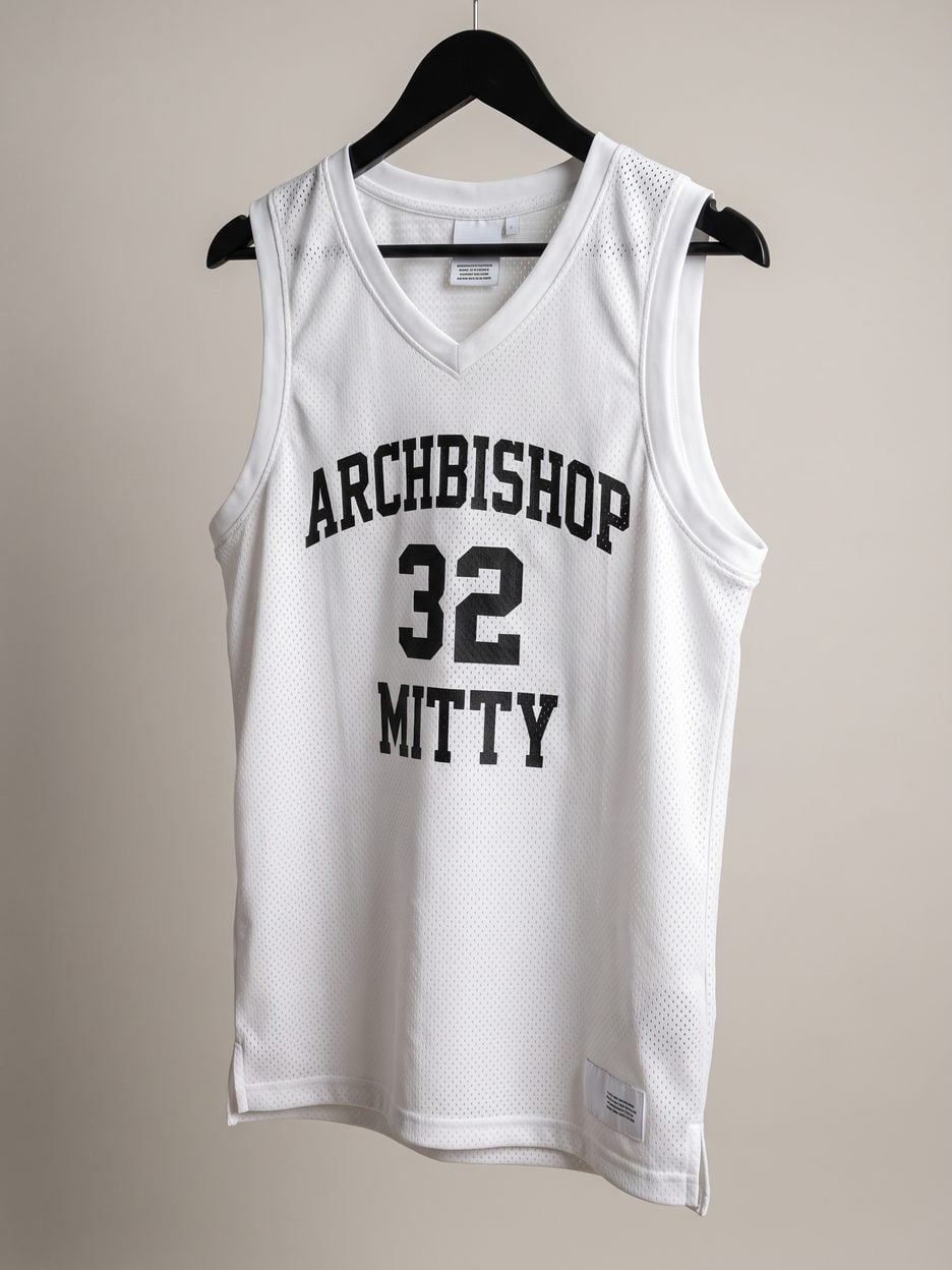 This jersey on a hanger, close enough to see the stitching, the fabric and the tags