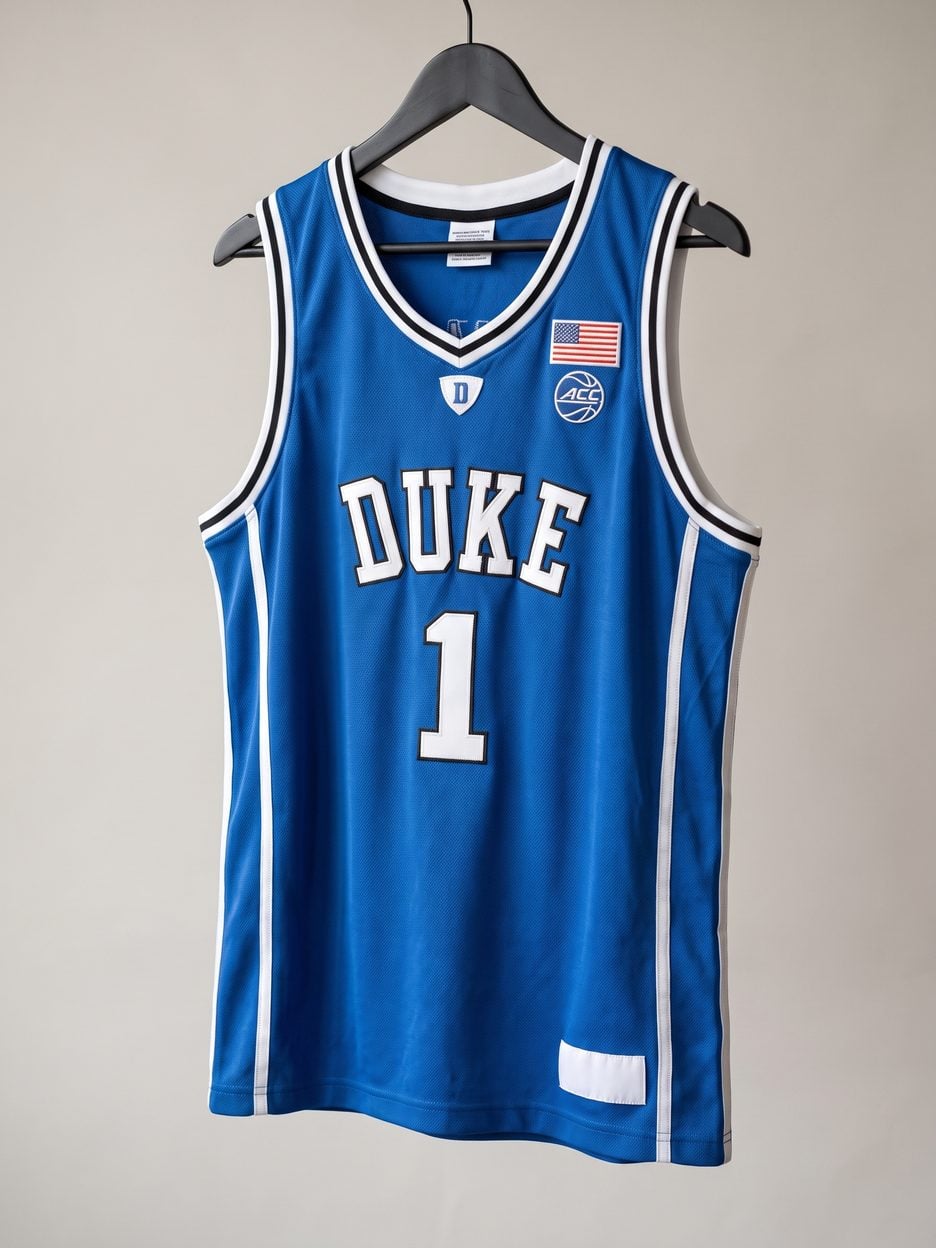 This jersey on a hanger, close enough to see the stitching, the fabric and the tags