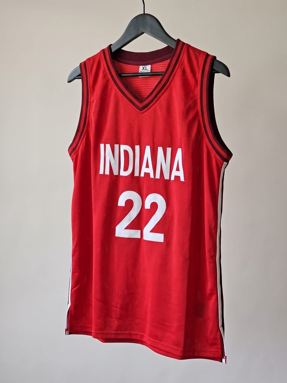 This jersey on a hanger, close enough to see the stitching, the fabric and the tags