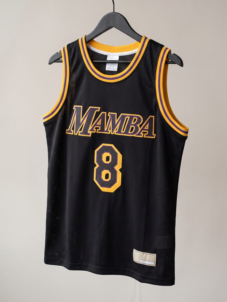 This jersey on a hanger, close enough to see the stitching, the fabric and the tags