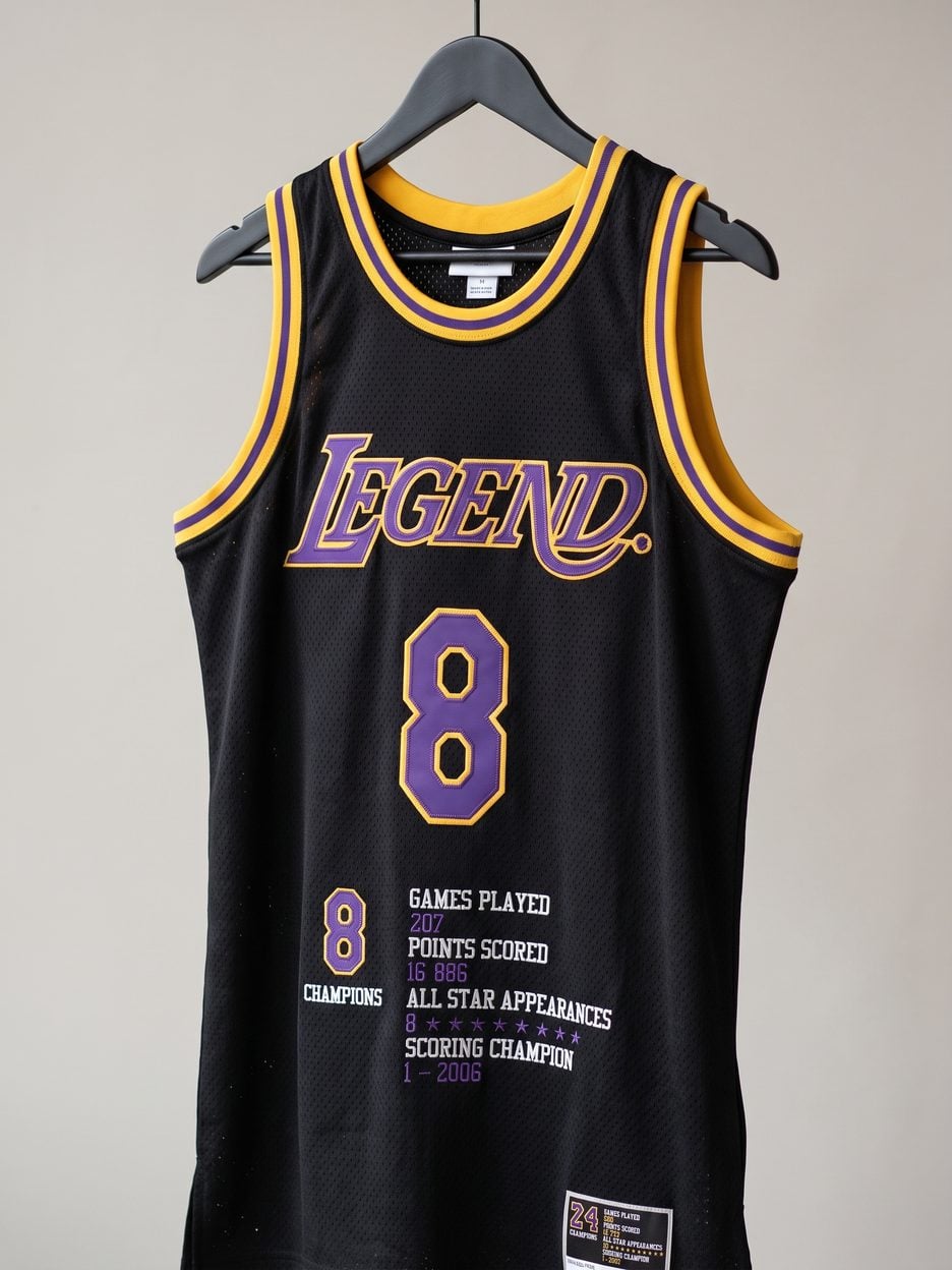 This jersey on a hanger, close enough to see the stitching, the fabric and the tags
