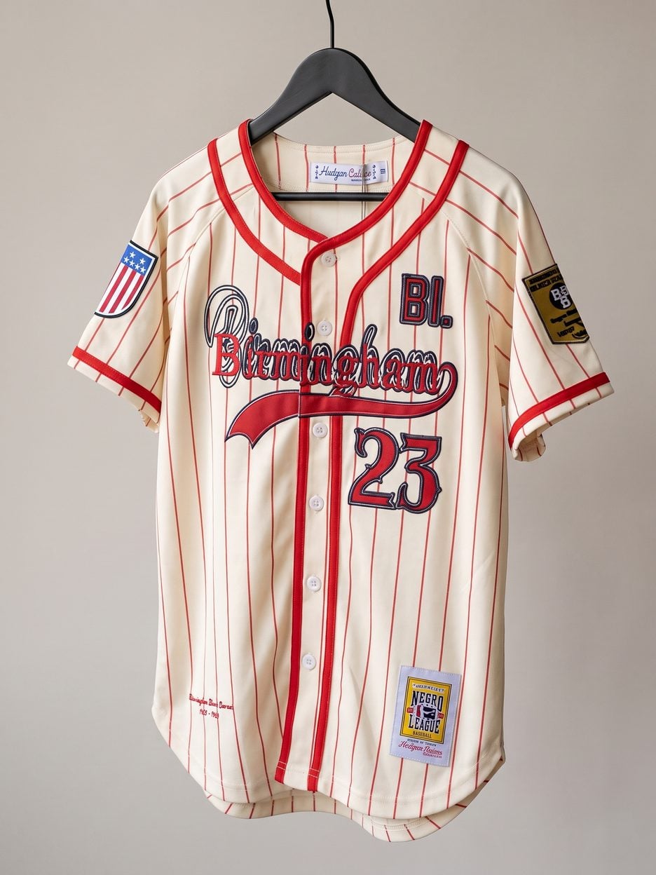 This jersey on a hanger, close enough to see the stitching, the fabric and the tags