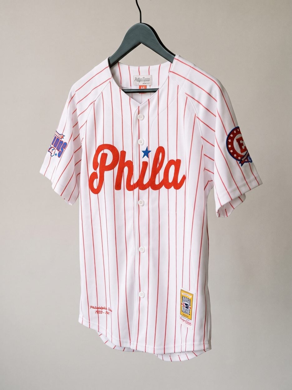 This jersey on a hanger, close enough to see the stitching, the fabric and the tags