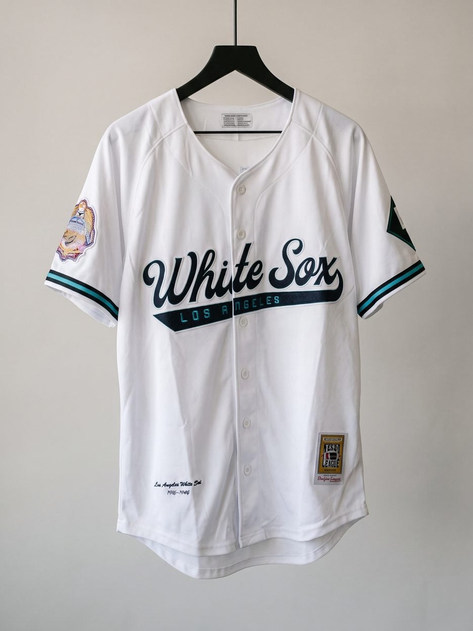 This jersey on a hanger, close enough to see the stitching, the fabric and the tags
