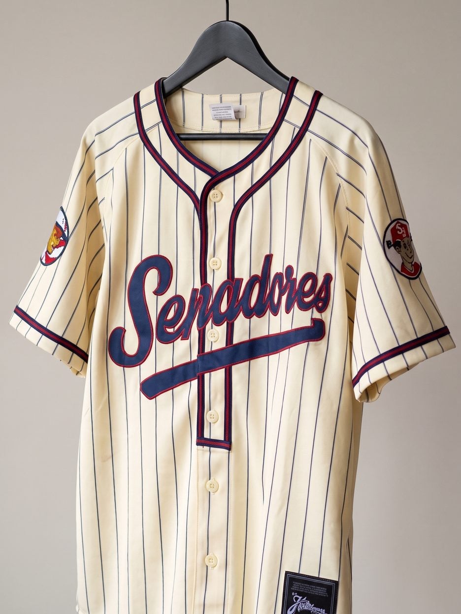 This jersey on a hanger, close enough to see the stitching, the fabric and the tags