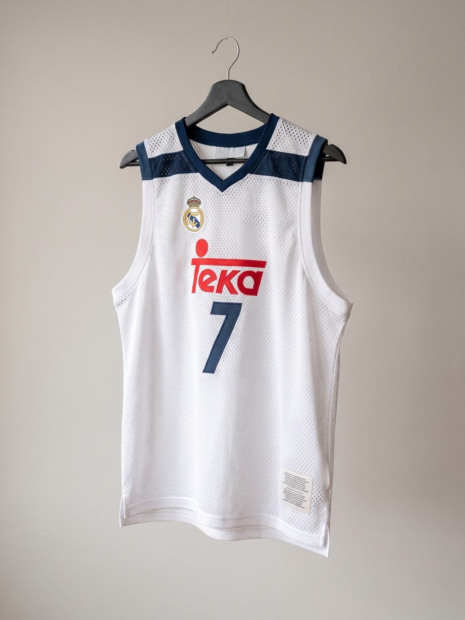 This jersey on a hanger, close enough to see the stitching, the fabric and the tags