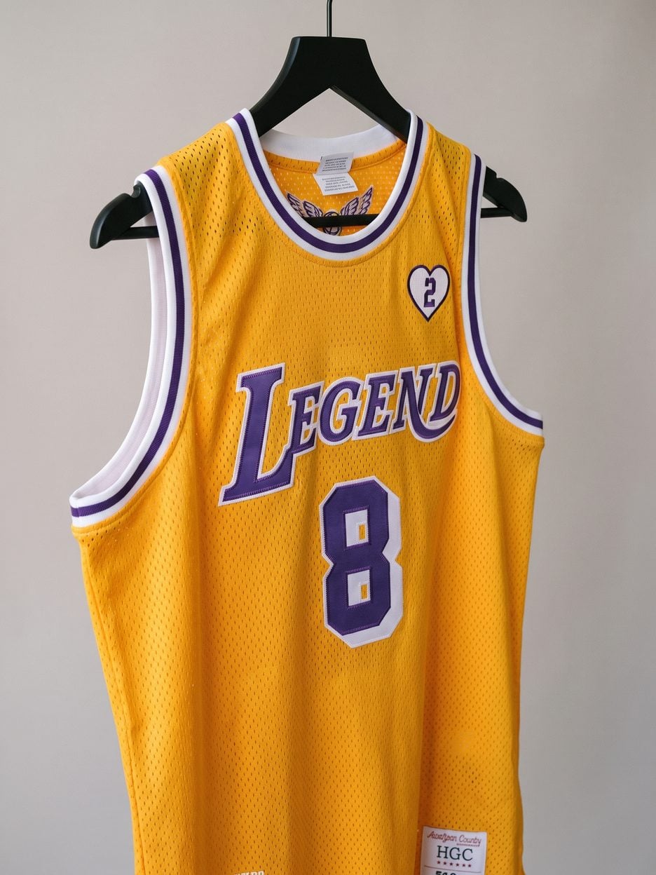 This jersey on a hanger, close enough to see the stitching, the fabric and the tags