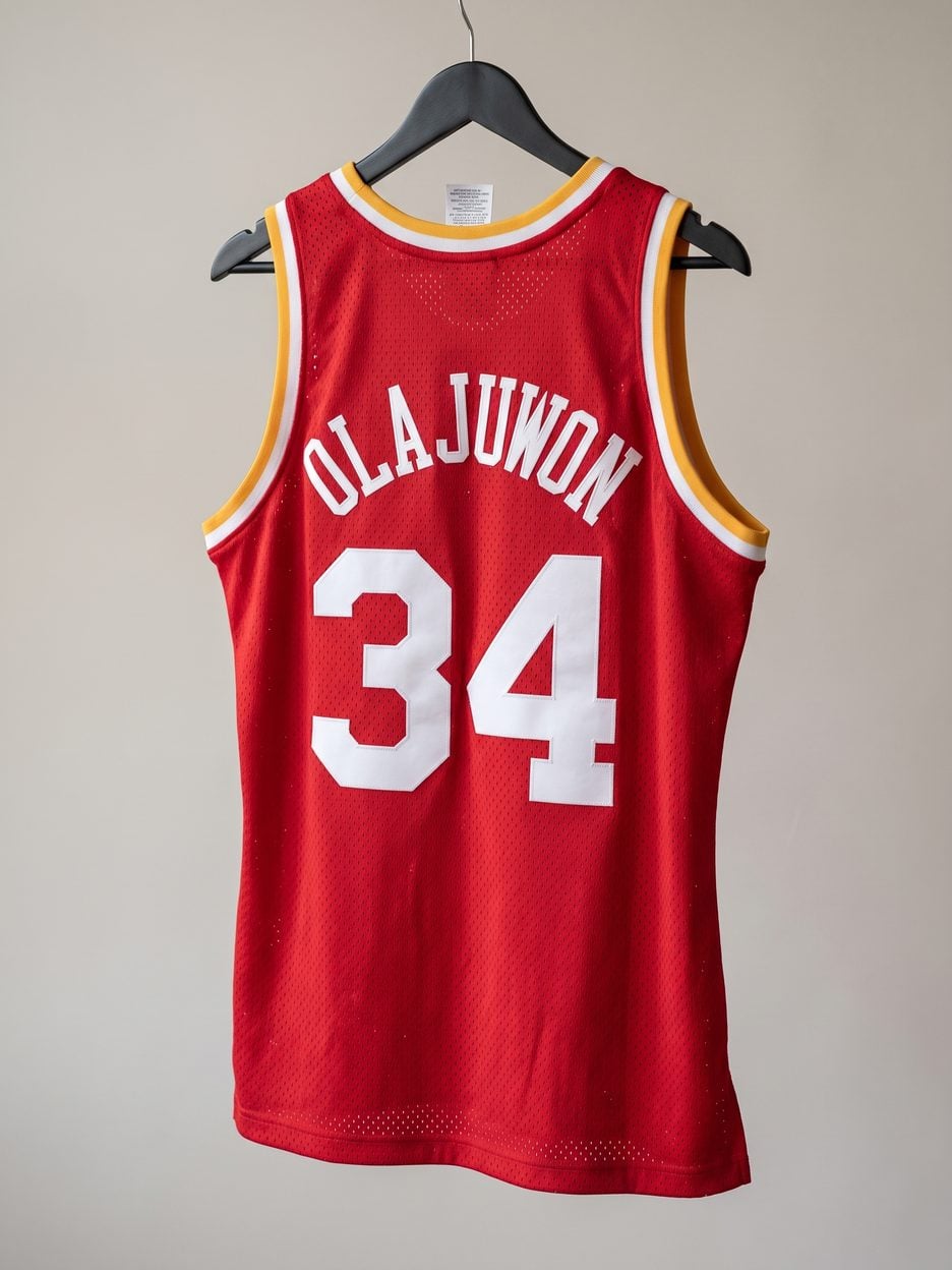 This jersey on a hanger, close enough to see the stitching, the fabric and the tags