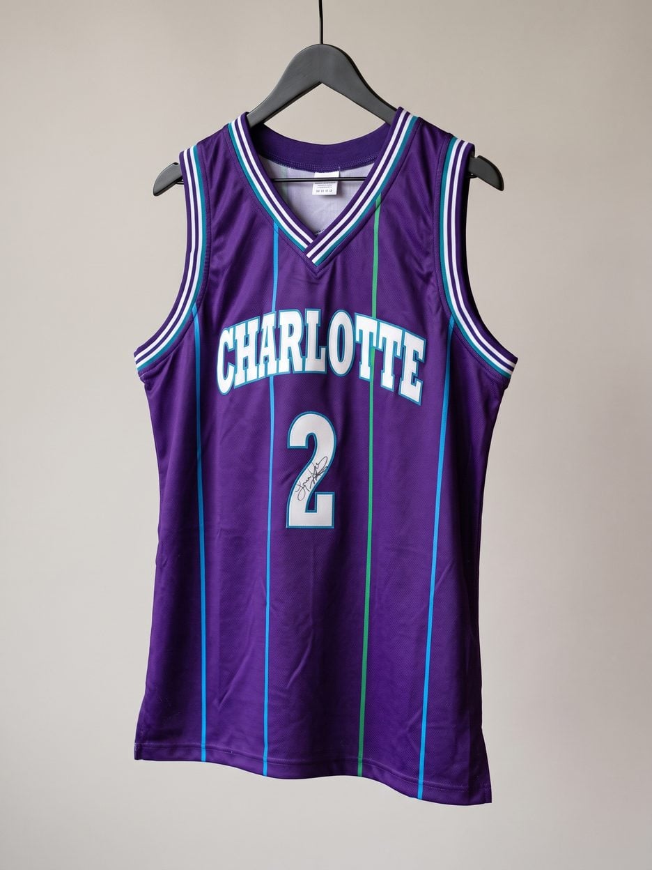 This jersey on a hanger, close enough to see the stitching, the fabric and the tags