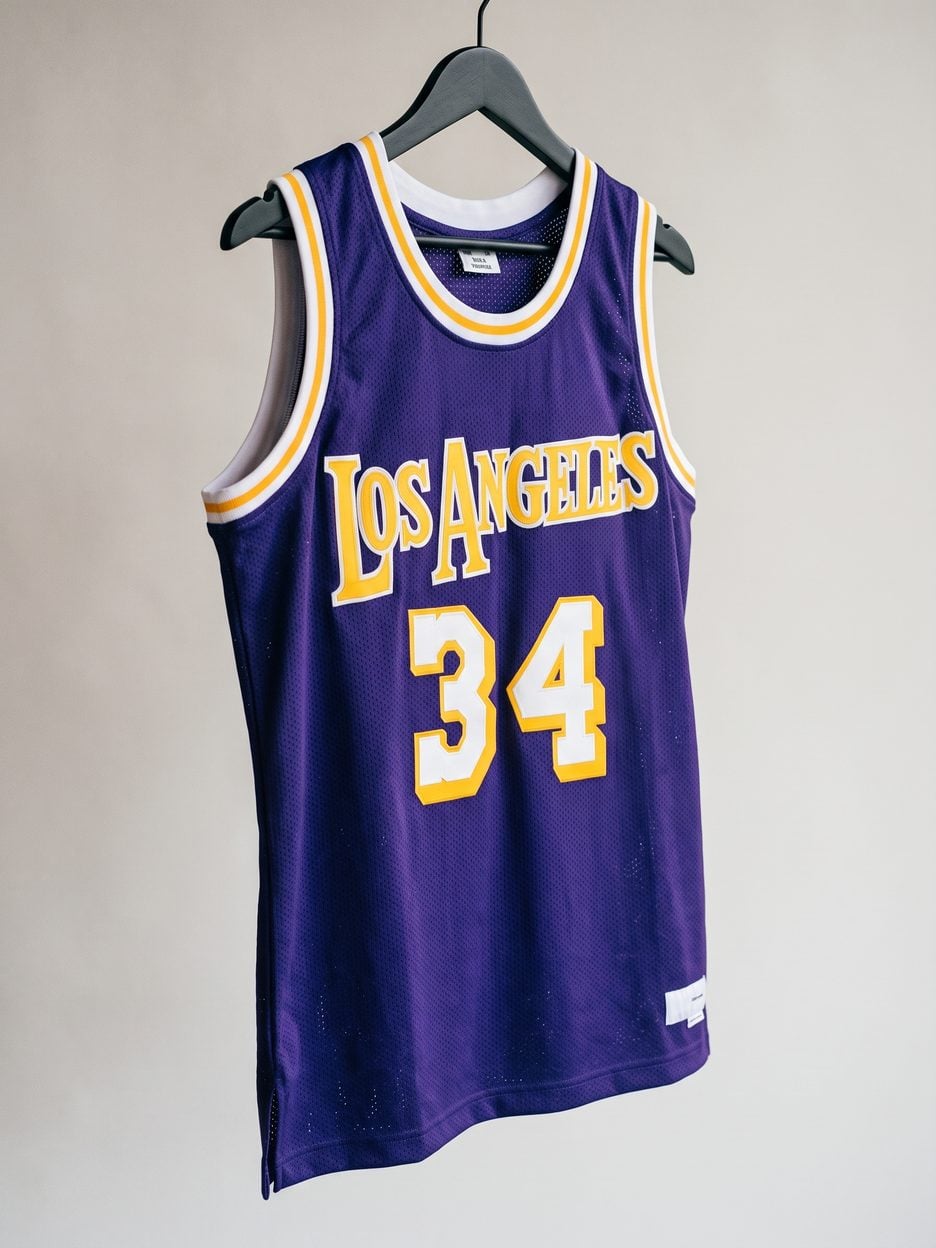 This jersey on a hanger, close enough to see the stitching, the fabric and the tags