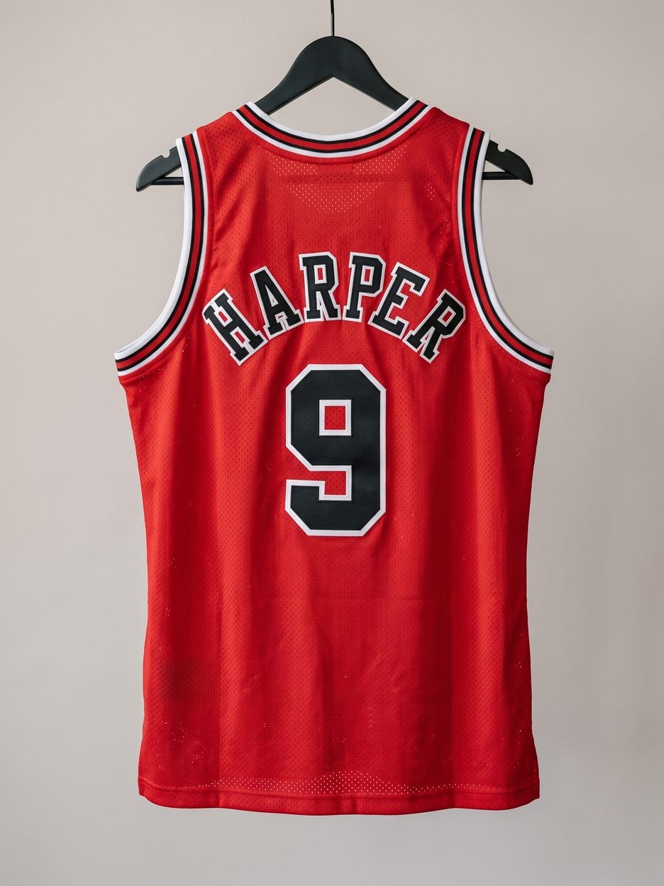 This jersey on a hanger, close enough to see the stitching, the fabric and the tags