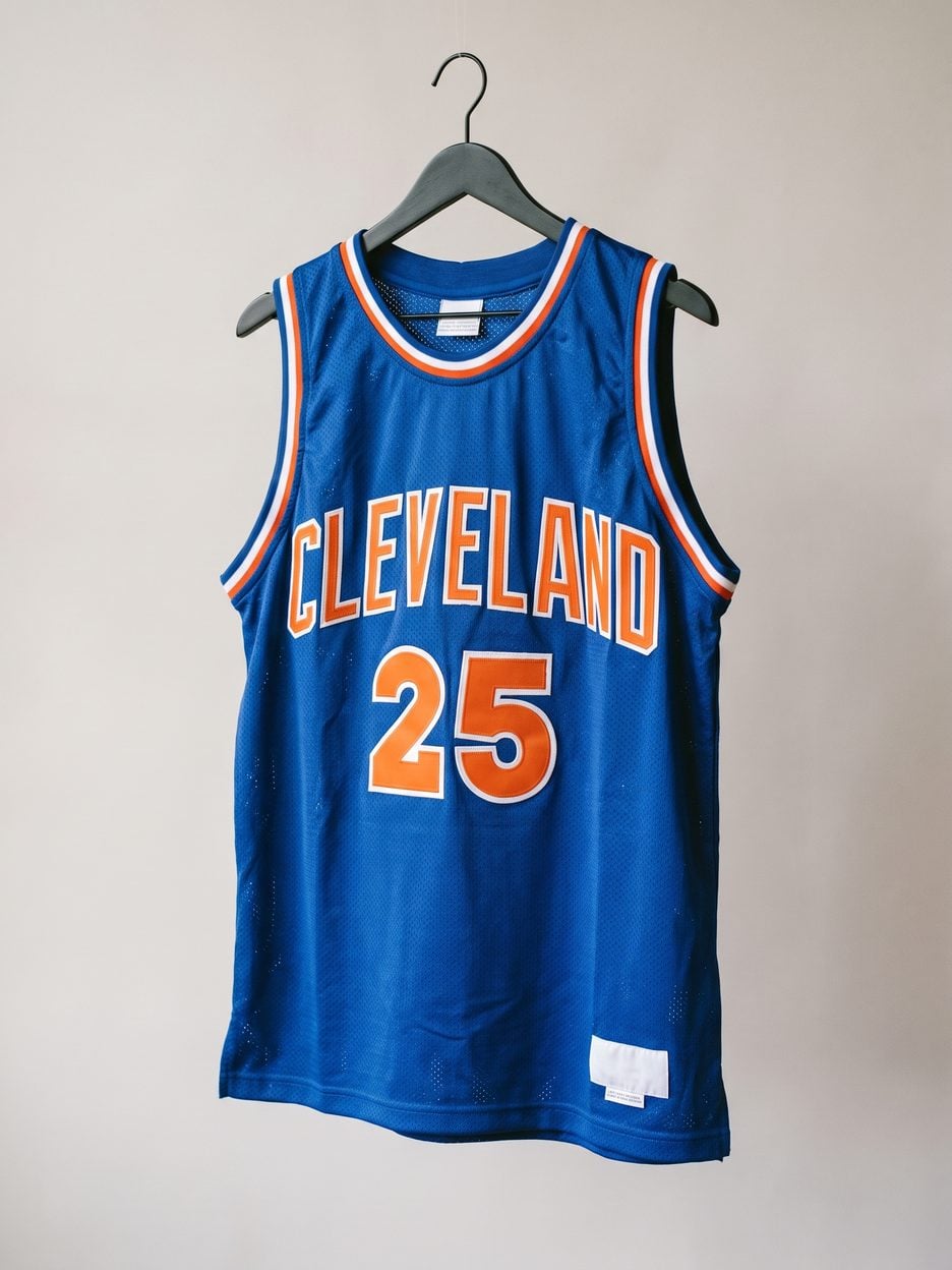 This jersey on a hanger, close enough to see the stitching, the fabric and the tags