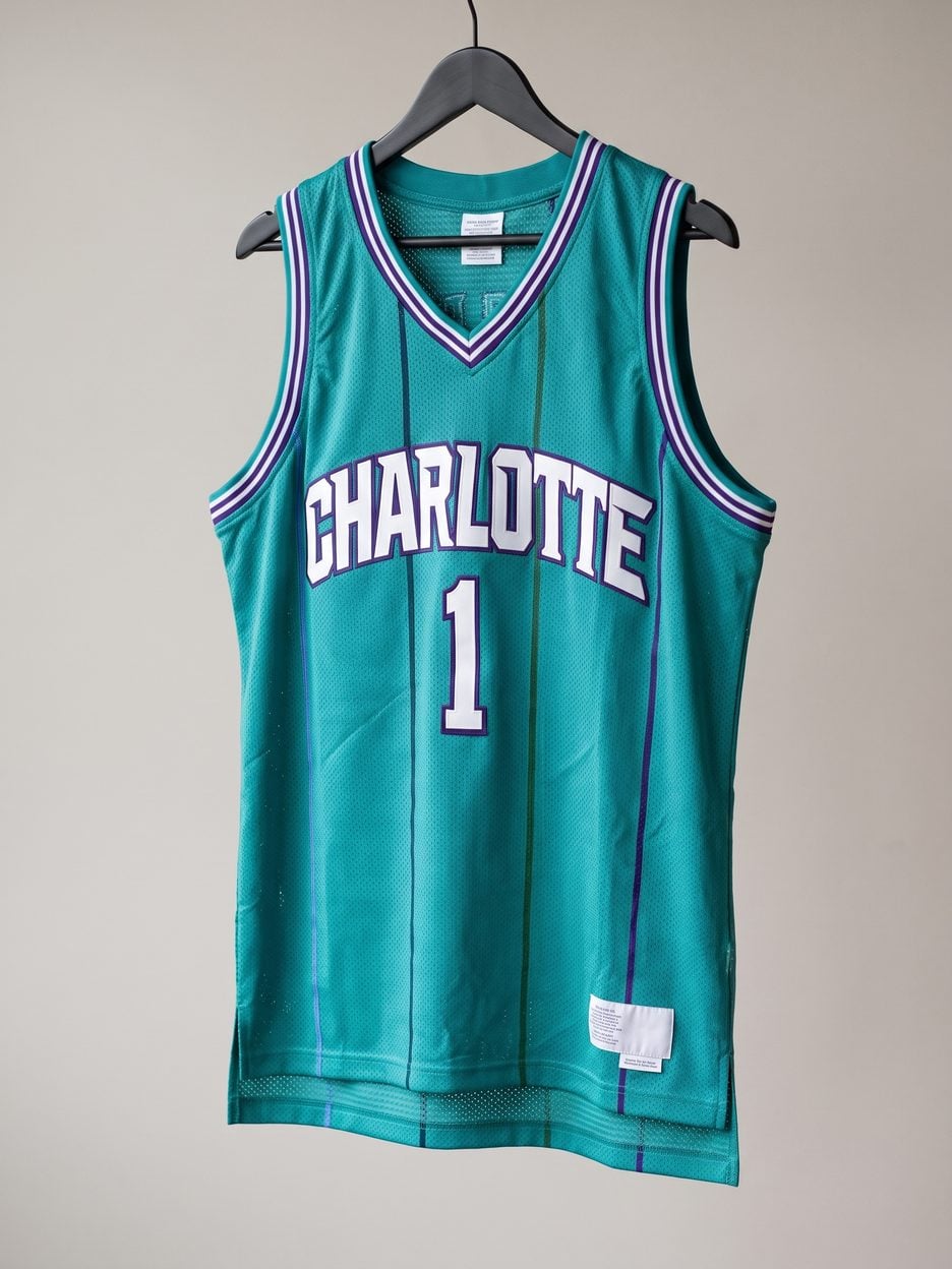 This jersey on a hanger, close enough to see the stitching, the fabric and the tags