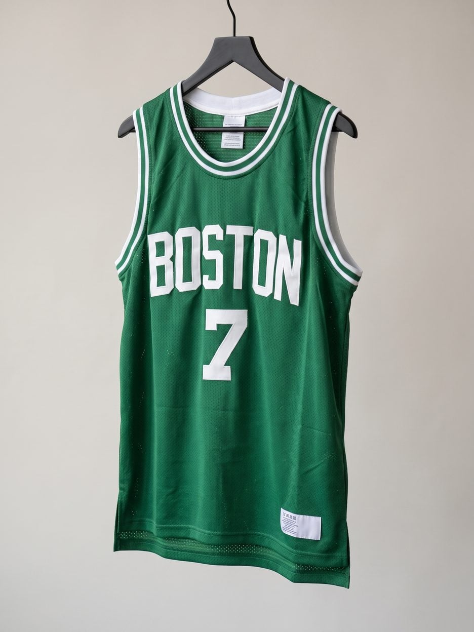 This jersey on a hanger, close enough to see the stitching, the fabric and the tags