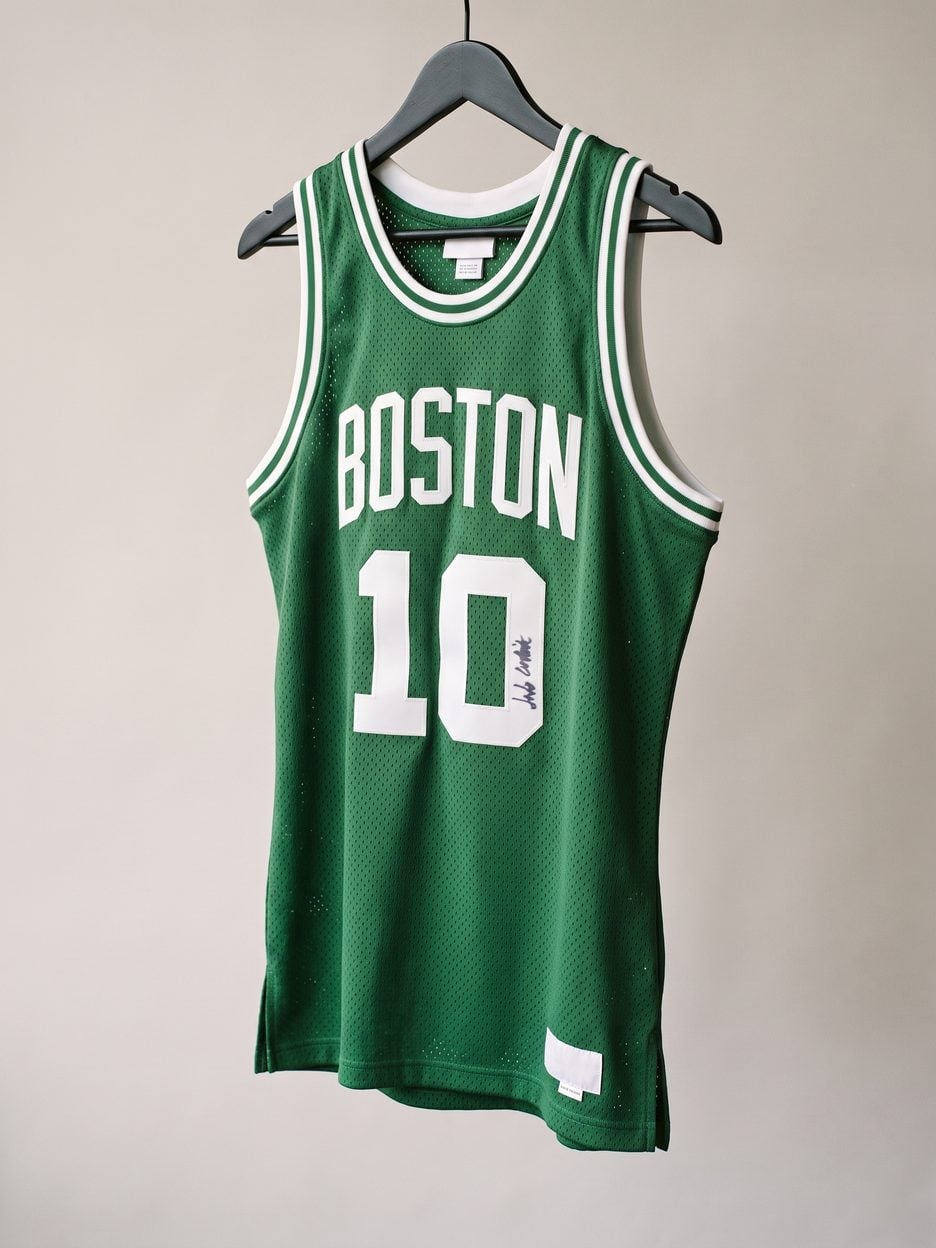 This jersey on a hanger, close enough to see the stitching, the fabric and the tags