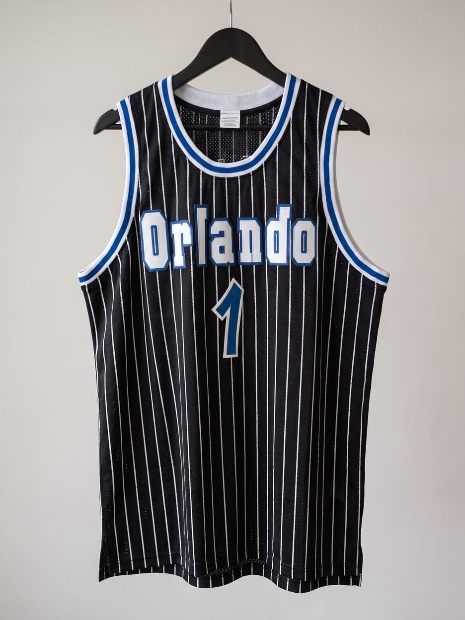 This jersey on a hanger, close enough to see the stitching, the fabric and the tags