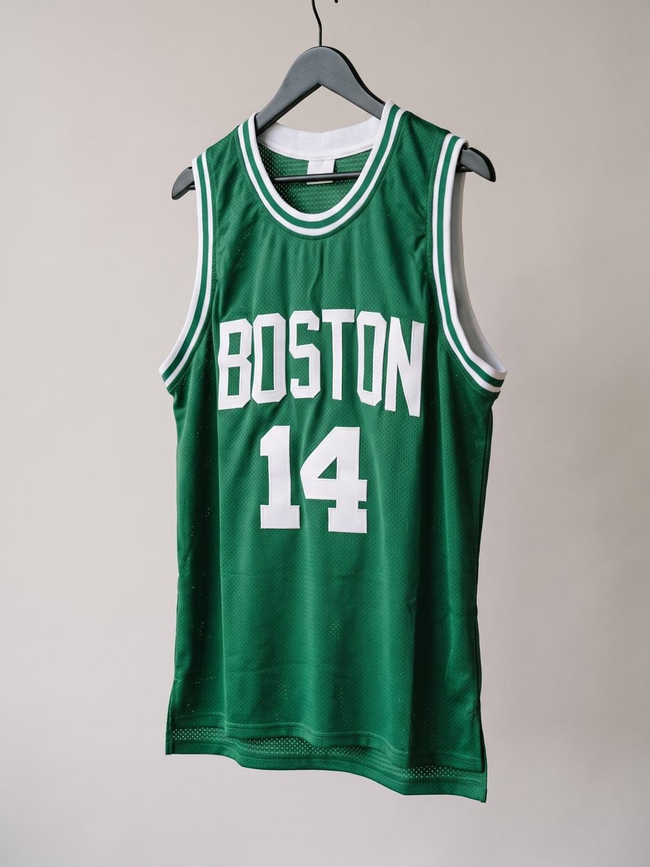 This jersey on a hanger, close enough to see the stitching, the fabric and the tags
