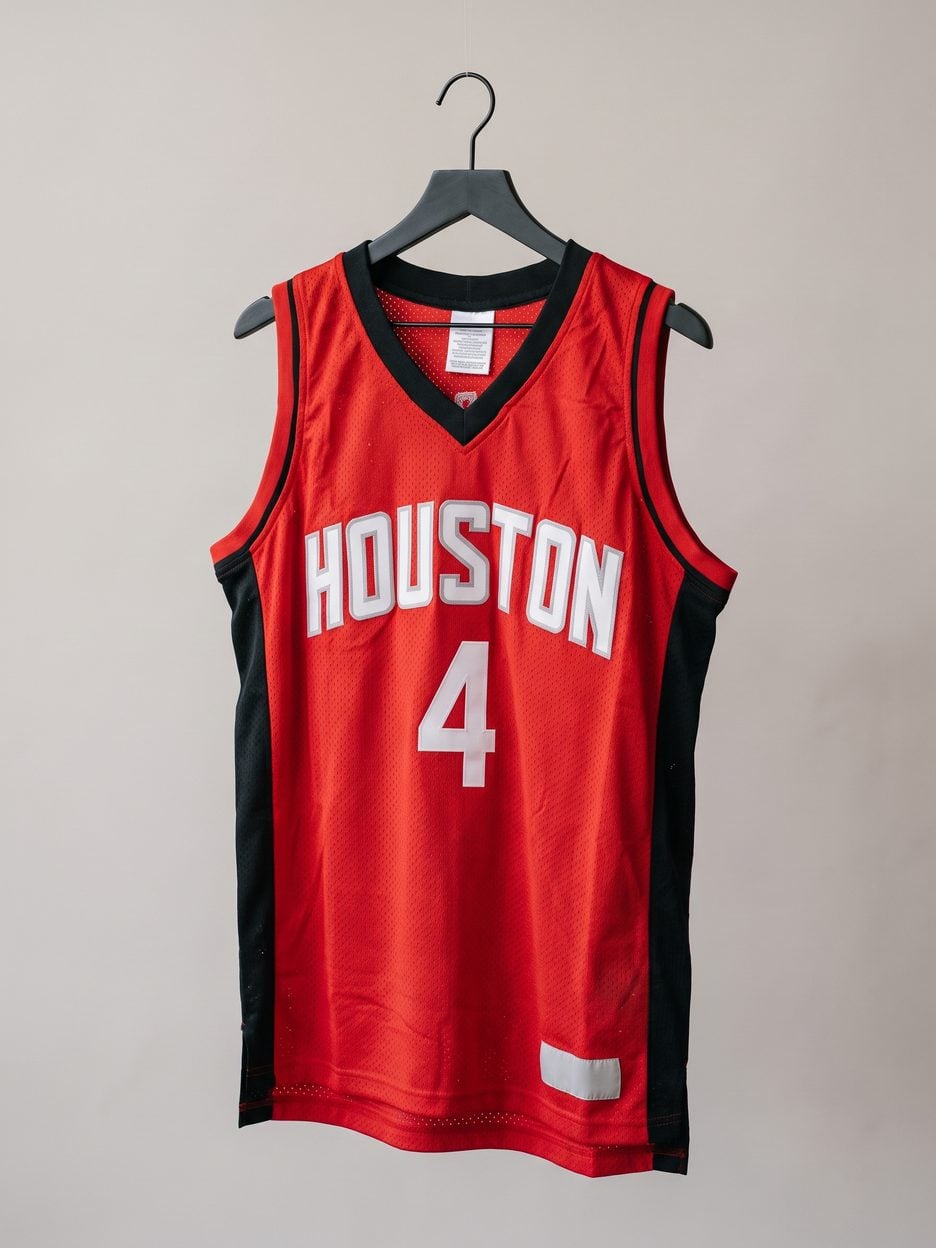 This jersey on a hanger, close enough to see the stitching, the fabric and the tags