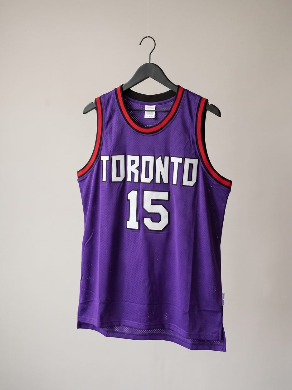 This jersey on a hanger, close enough to see the stitching, the fabric and the tags