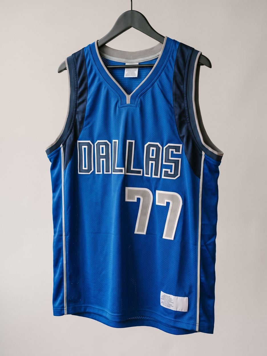 This jersey on a hanger, close enough to see the stitching, the fabric and the tags