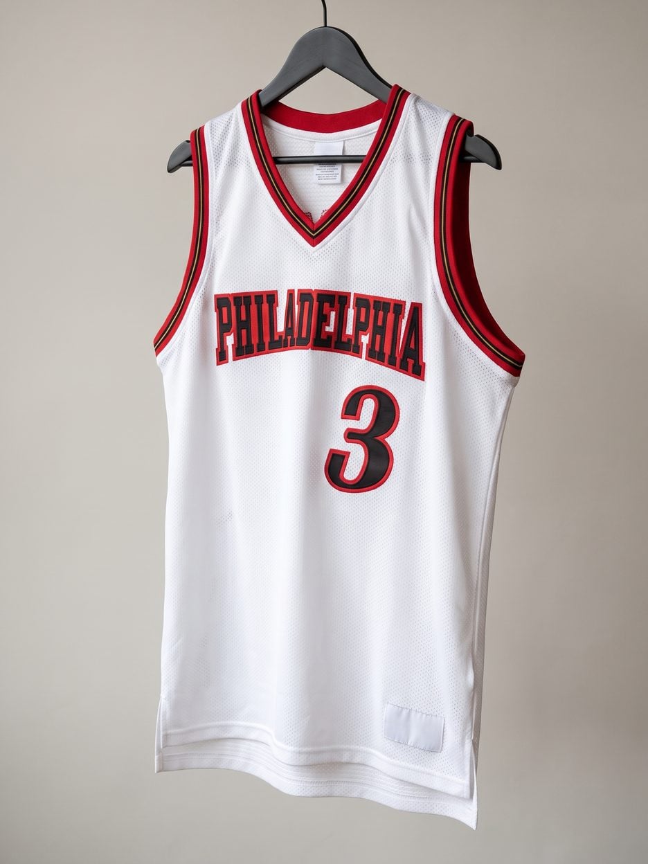 This jersey on a hanger, close enough to see the stitching, the fabric and the tags