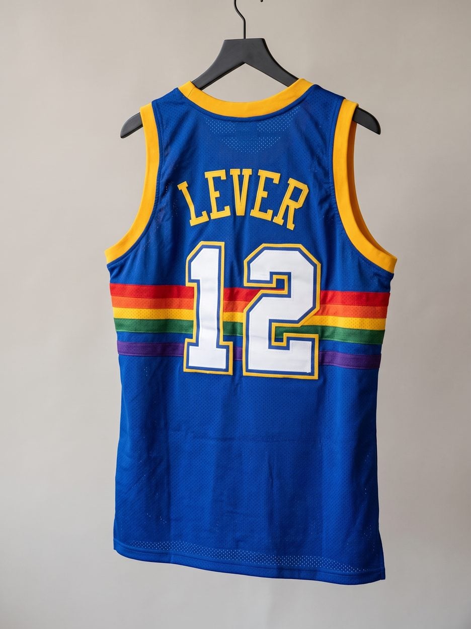 This jersey on a hanger, close enough to see the stitching, the fabric and the tags