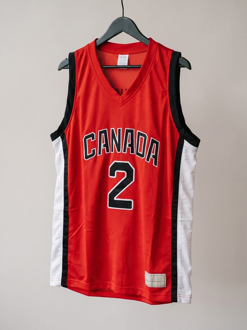 This jersey on a hanger, close enough to see the stitching, the fabric and the tags