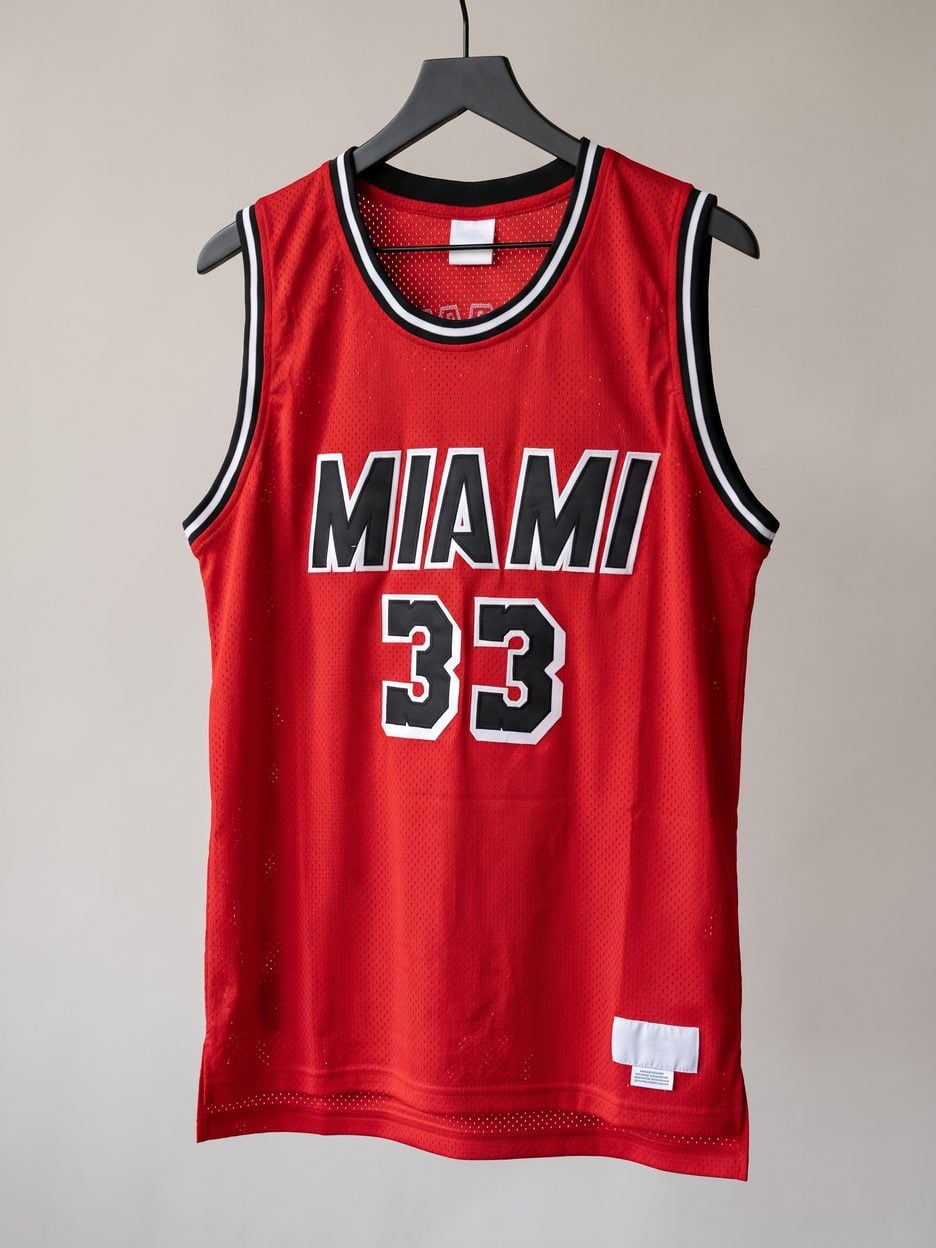 This jersey on a hanger, close enough to see the stitching, the fabric and the tags