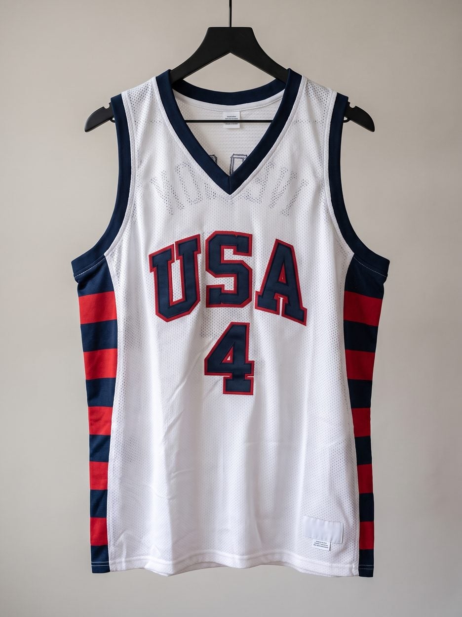 This jersey on a hanger, close enough to see the stitching, the fabric and the tags