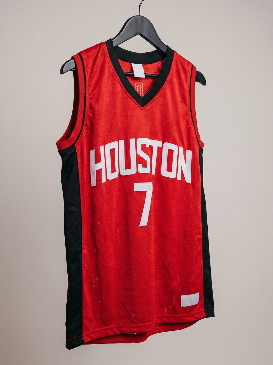 This jersey on a hanger, close enough to see the stitching, the fabric and the tags
