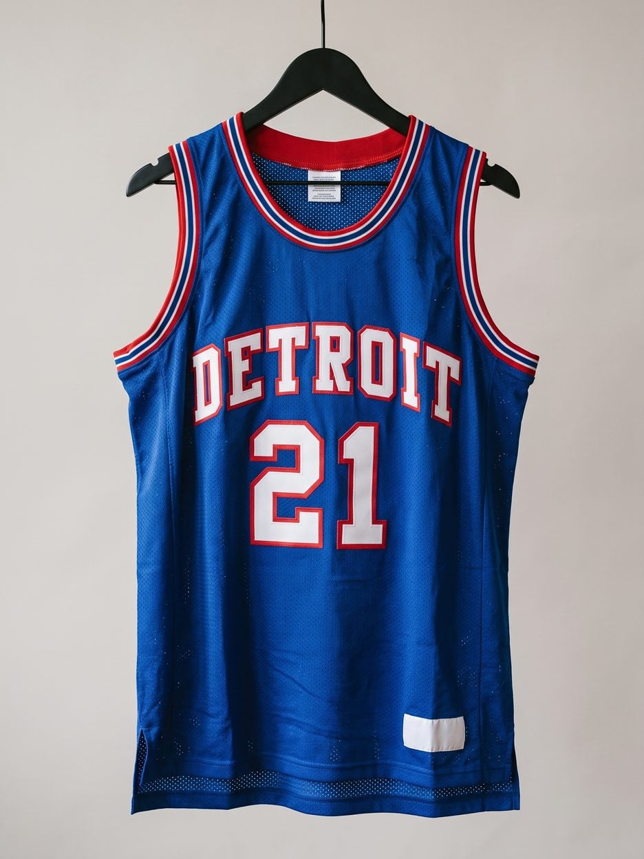 This jersey on a hanger, close enough to see the stitching, the fabric and the tags