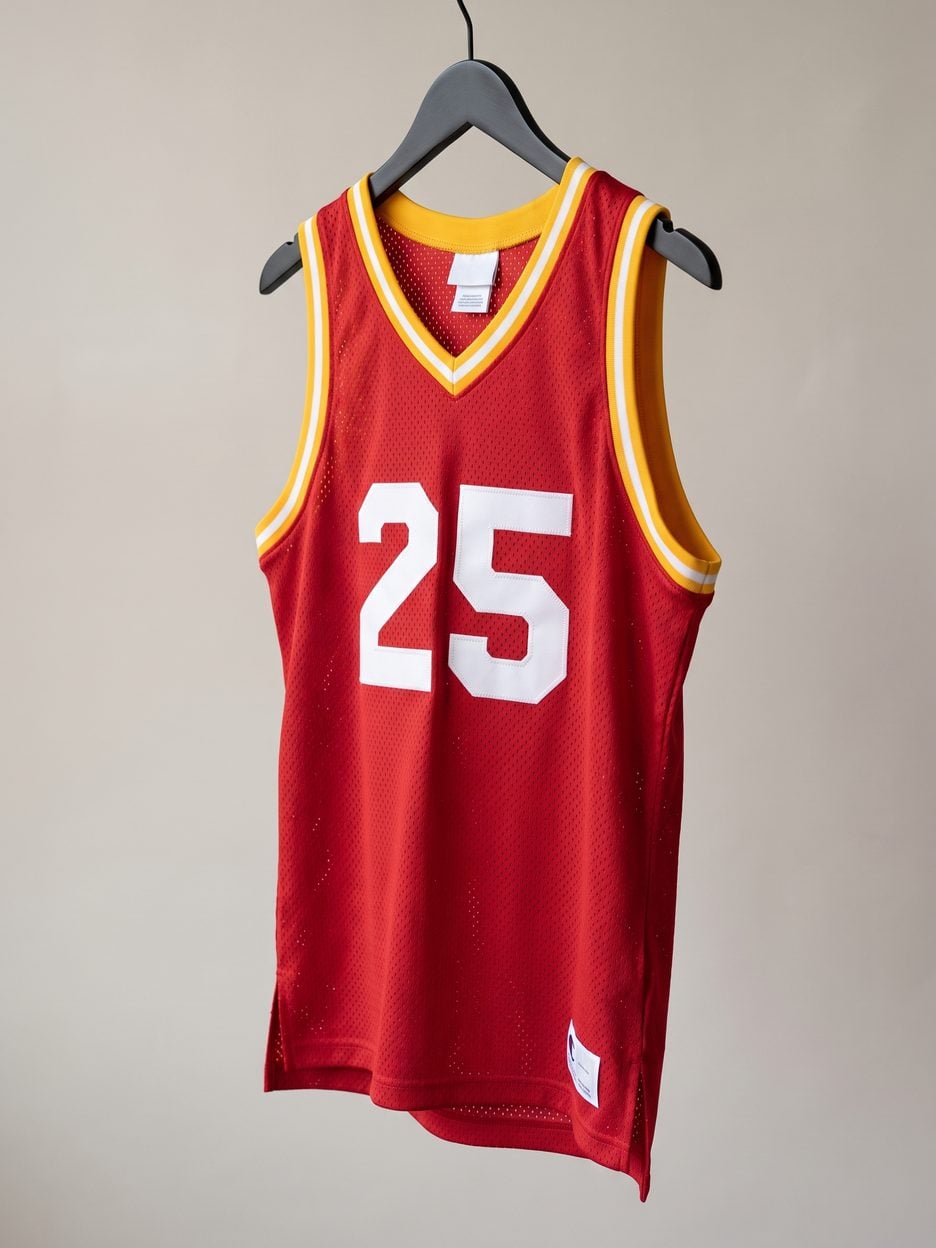 This jersey on a hanger, close enough to see the stitching, the fabric and the tags