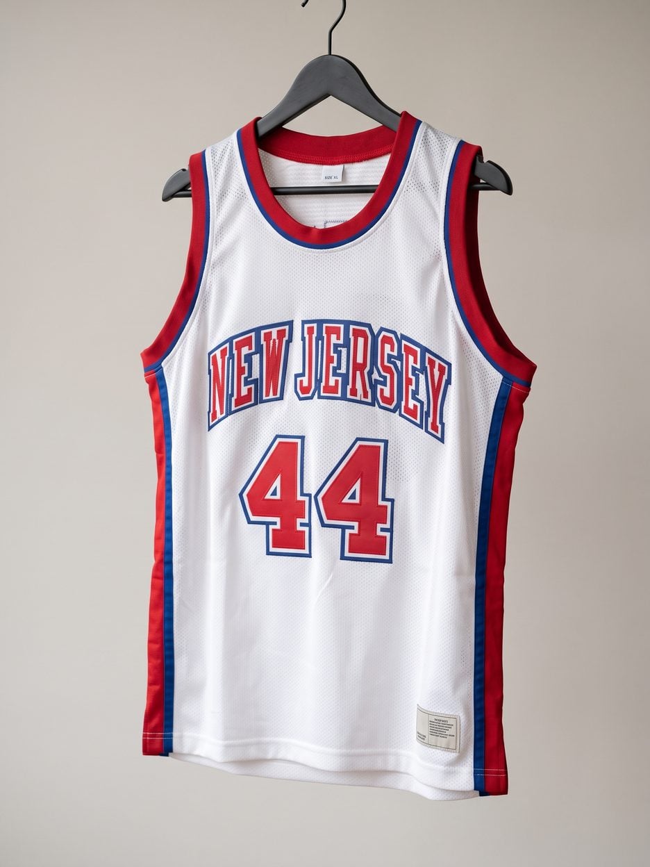 This jersey on a hanger, close enough to see the stitching, the fabric and the tags