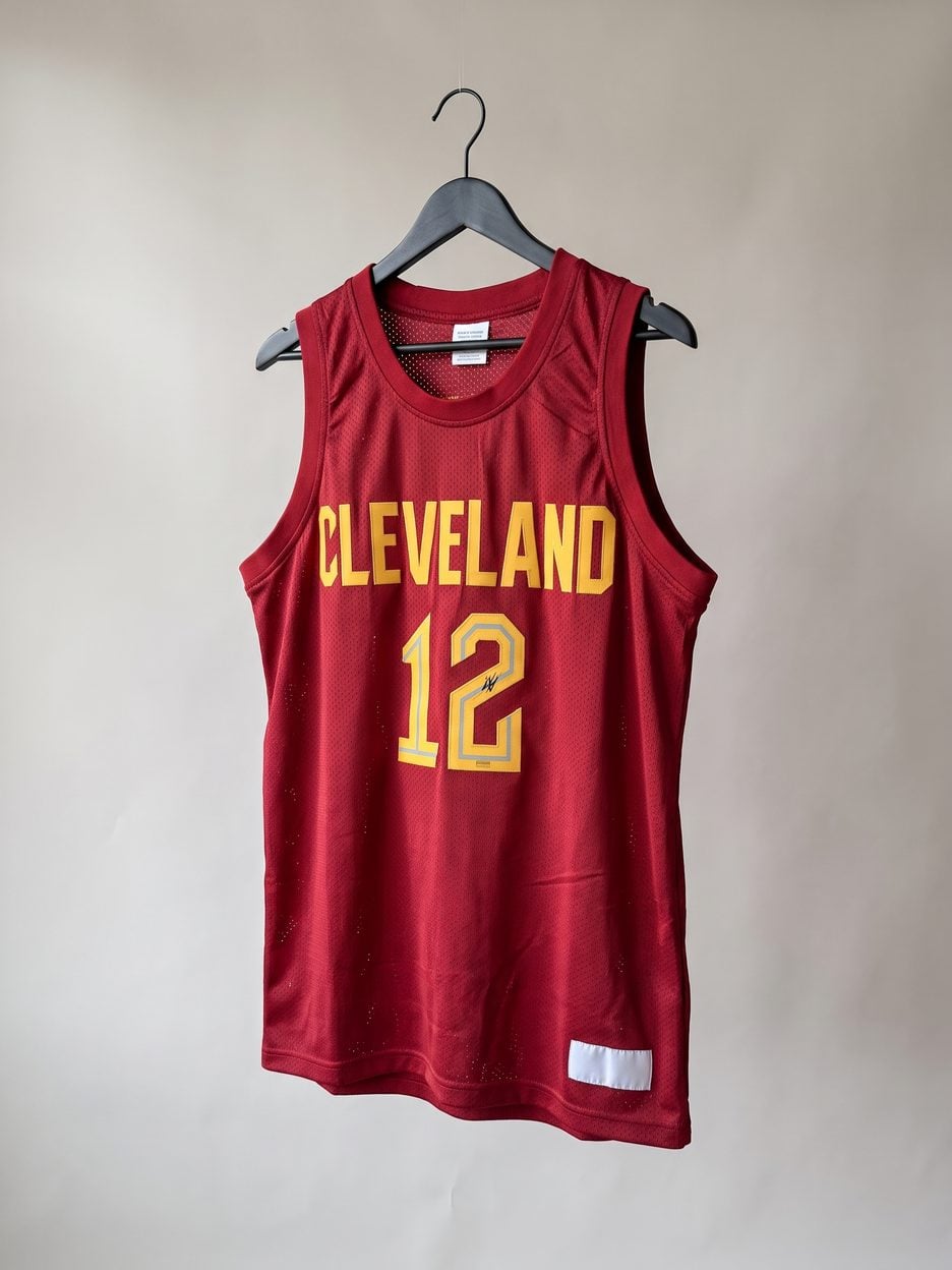 This jersey on a hanger, close enough to see the stitching, the fabric and the tags