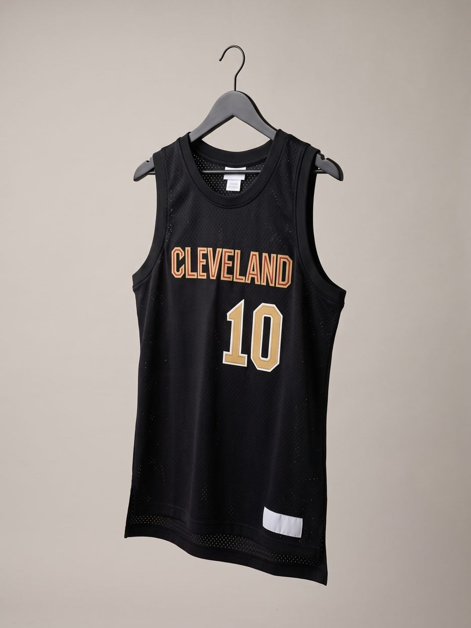 This jersey on a hanger, close enough to see the stitching, the fabric and the tags
