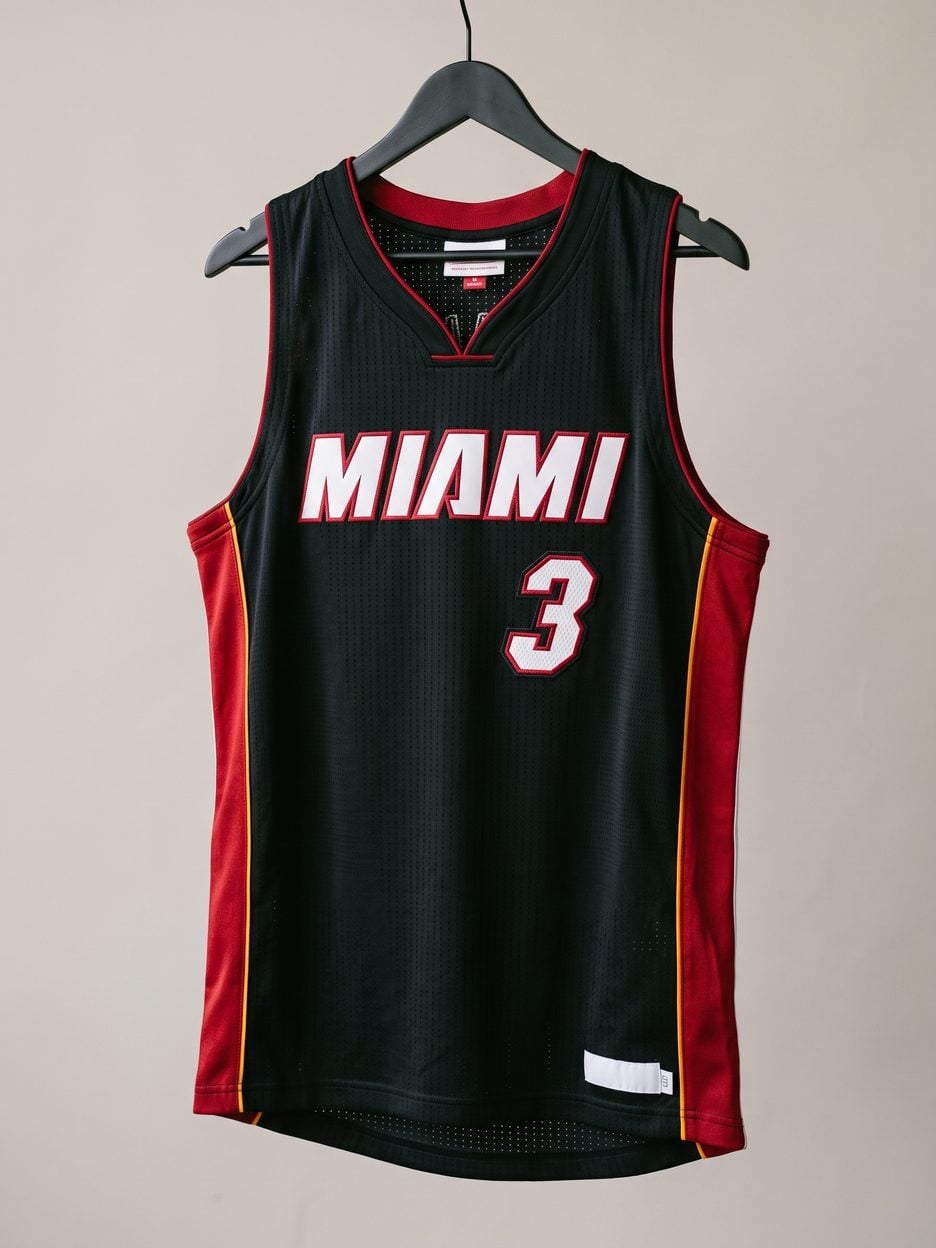 This jersey on a hanger, close enough to see the stitching, the fabric and the tags
