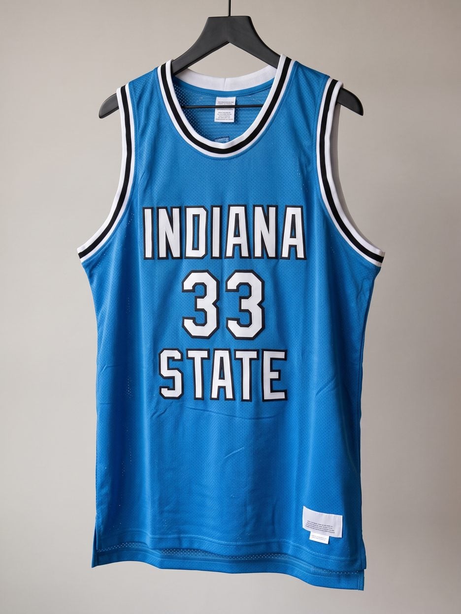 This jersey on a hanger, close enough to see the stitching, the fabric and the tags