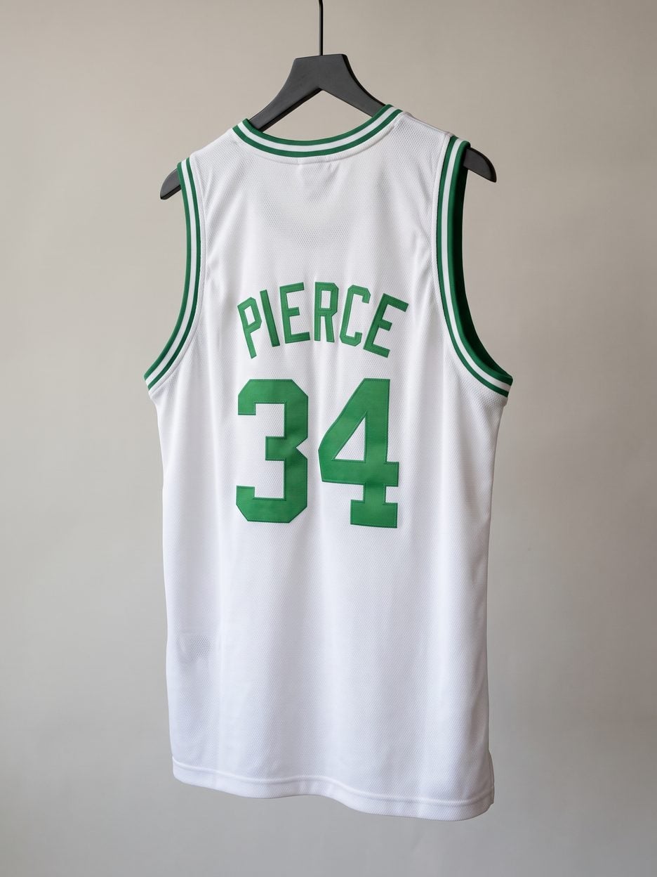 This jersey on a hanger, close enough to see the stitching, the fabric and the tags