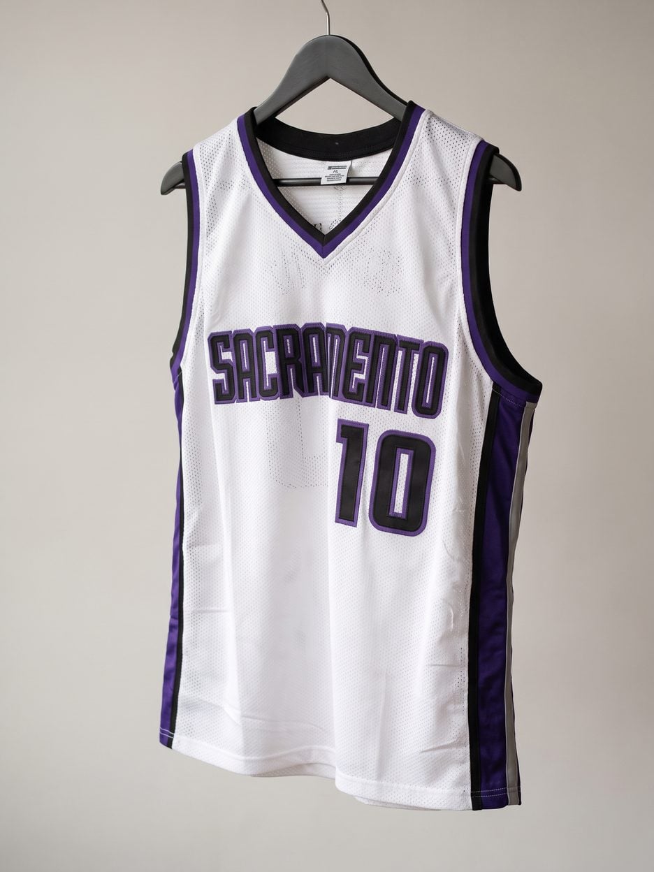 This jersey on a hanger, close enough to see the stitching, the fabric and the tags