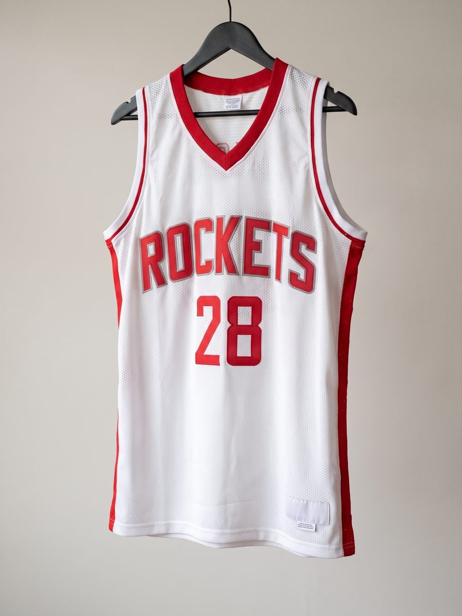This jersey on a hanger, close enough to see the stitching, the fabric and the tags