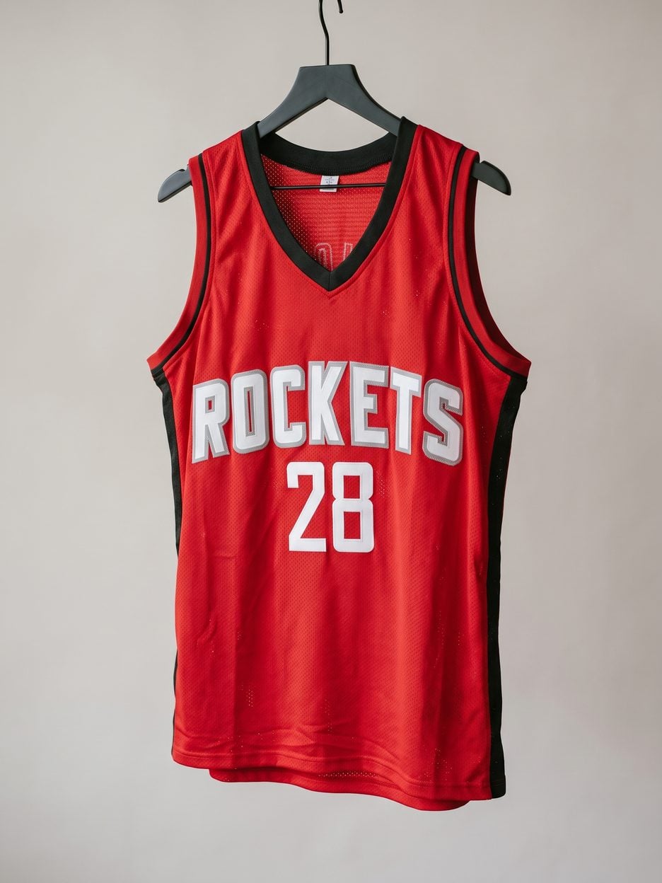 This jersey on a hanger, close enough to see the stitching, the fabric and the tags