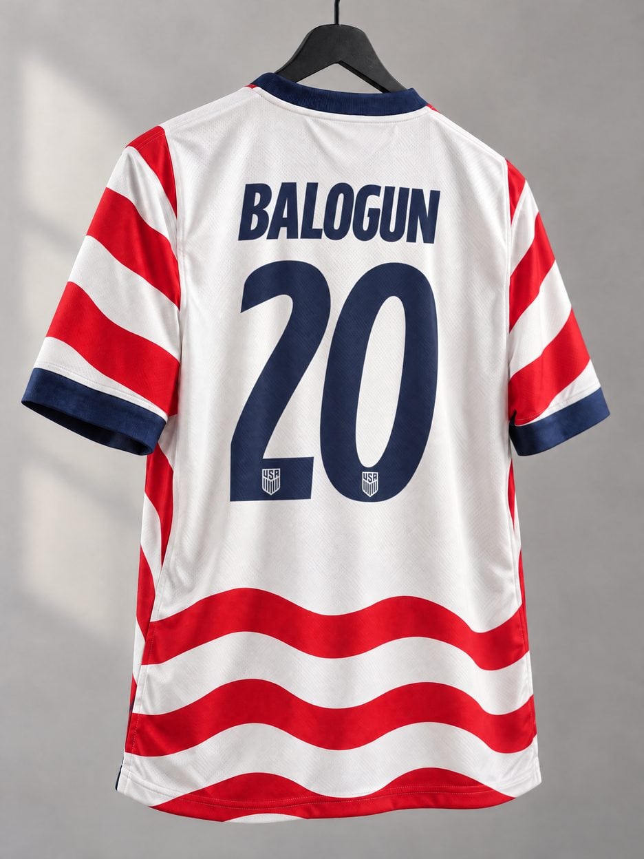The #20 Folarin Balogun USA Soccer Jersey on a hanger, seen from the back: the collar and cuff trim, the heat-pressed name and number, the colours in the fabric and the light knit