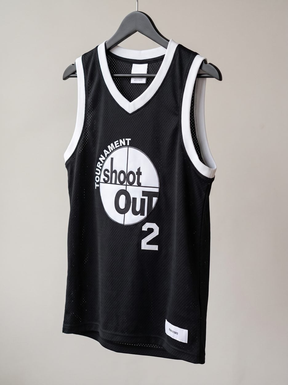 This jersey on a hanger, close enough to see the stitching, the fabric and the tags
