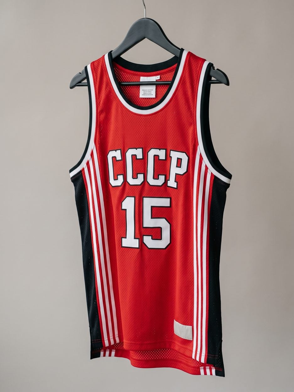This jersey on a hanger, close enough to see the stitching, the fabric and the tags