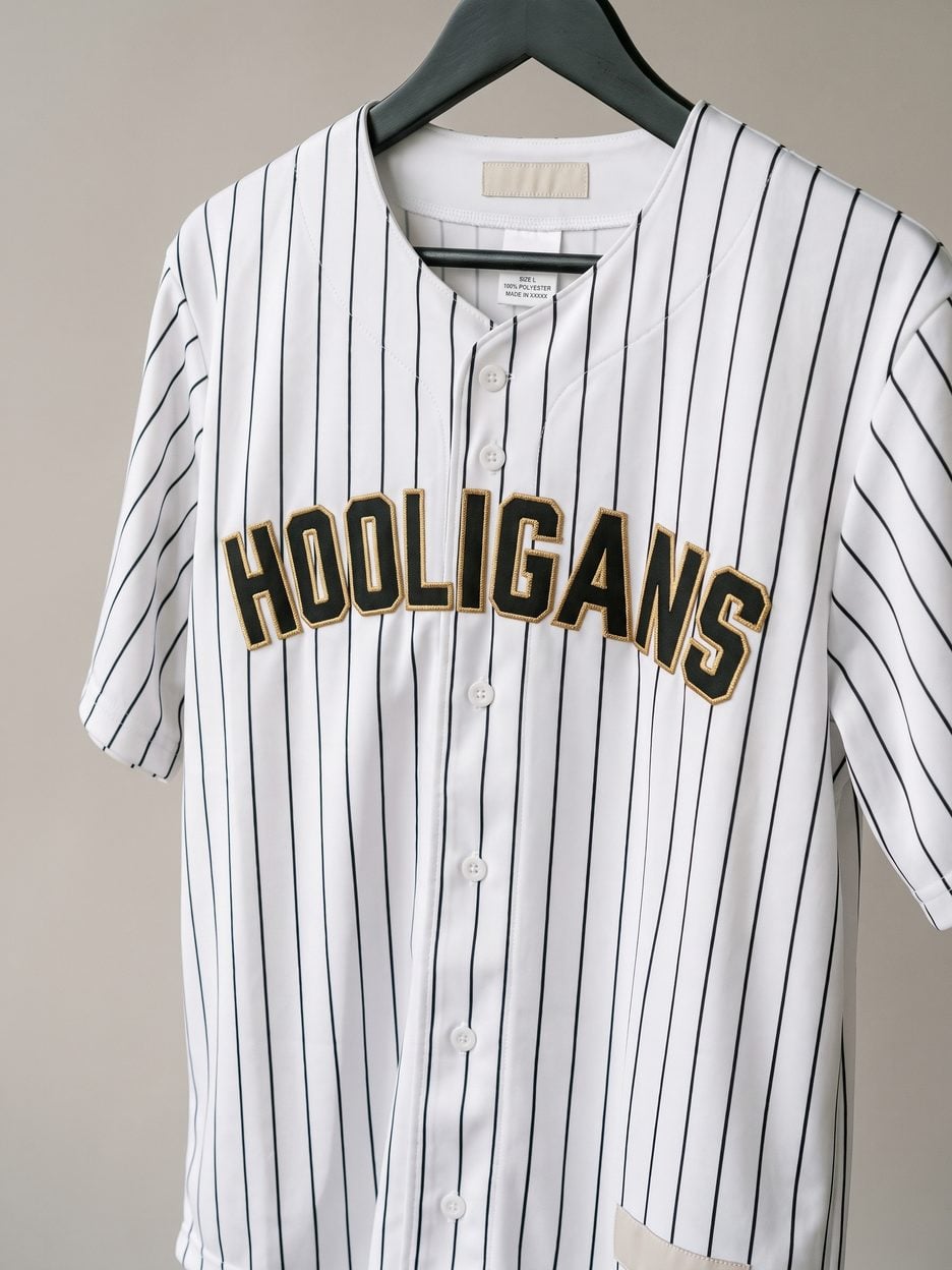 This jersey on a hanger, close enough to see the stitching, the fabric and the tags