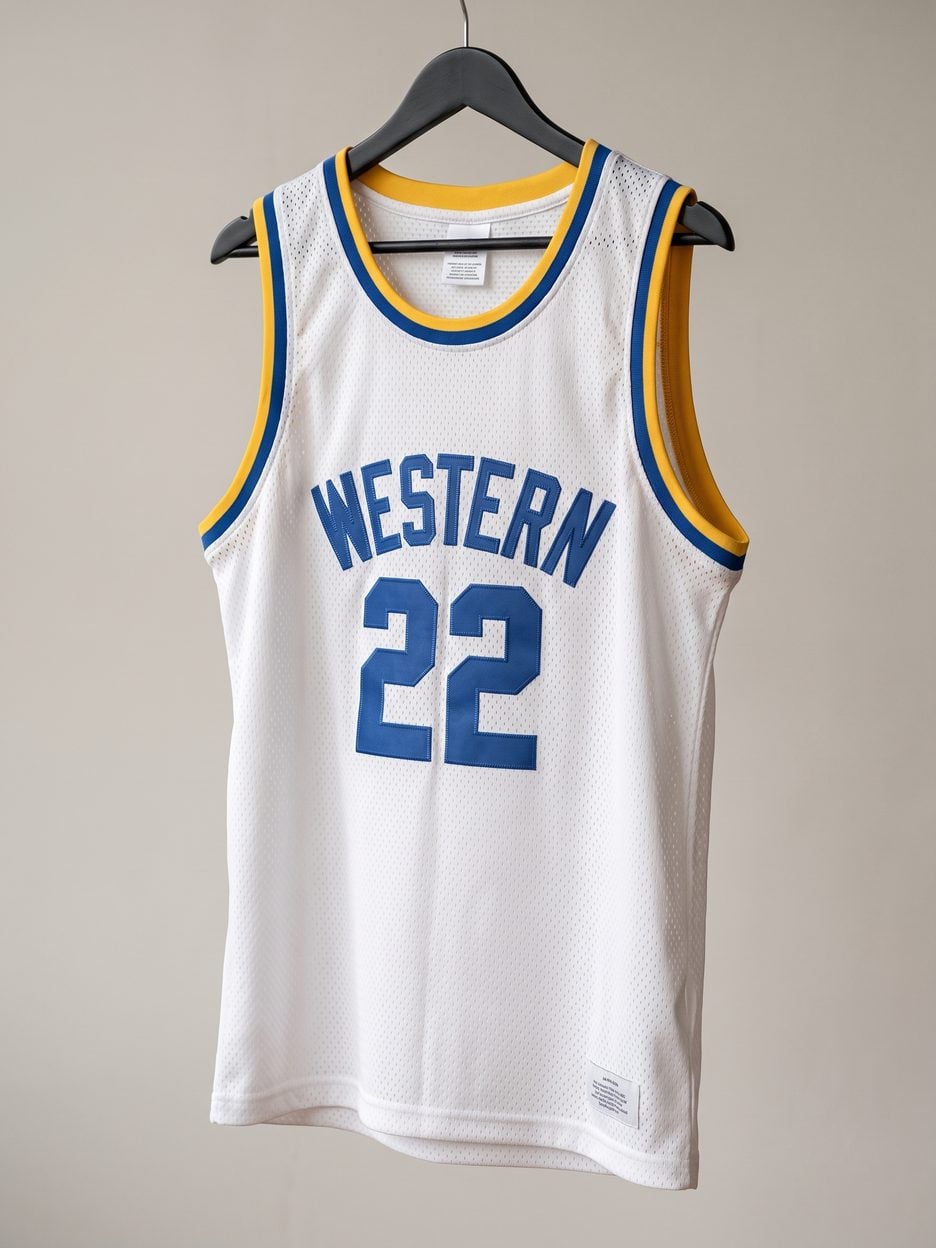 This jersey on a hanger, close enough to see the stitching, the fabric and the tags