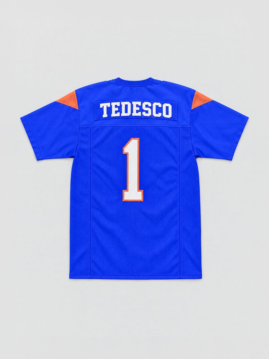 The Harmon Tedesco #1 Blue Mountain State Football Jersey laid flat, from the back: the stitched name plate and number on a mesh body