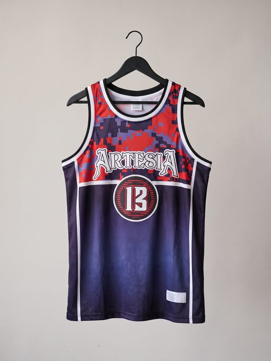 This jersey on a hanger, close enough to see the stitching, the fabric and the tags