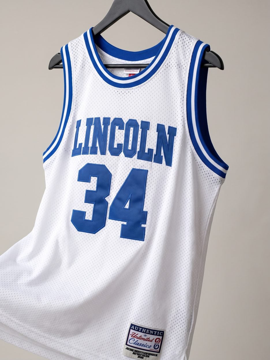 This jersey on a hanger, close enough to see the stitching, the fabric and the tags